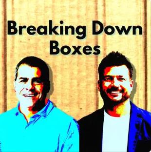 Breaking down boxes - two men standing next to each other.