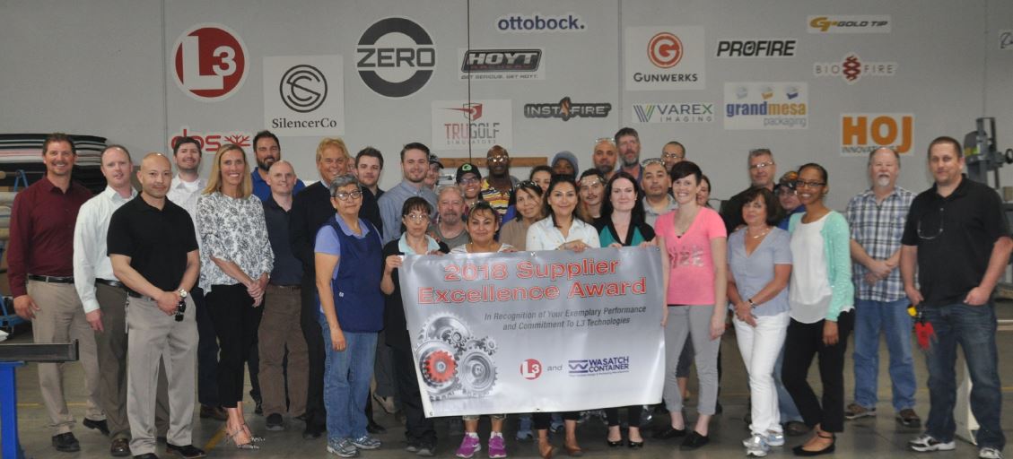 A group of people posing for a picture in a workshop.